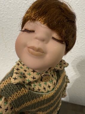 Vintage Porcelain Face Doll with Brown Hair and Green-Tan Knit Outfit